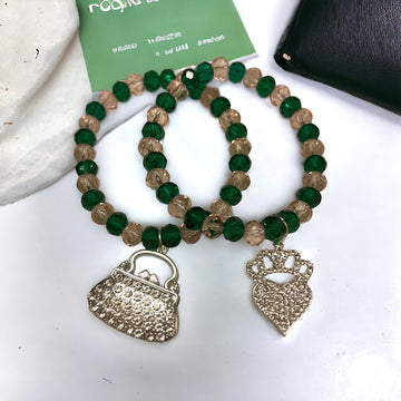 Green and pink beaded crystal bracelets with a heart wearing a crown charm and a purse charm