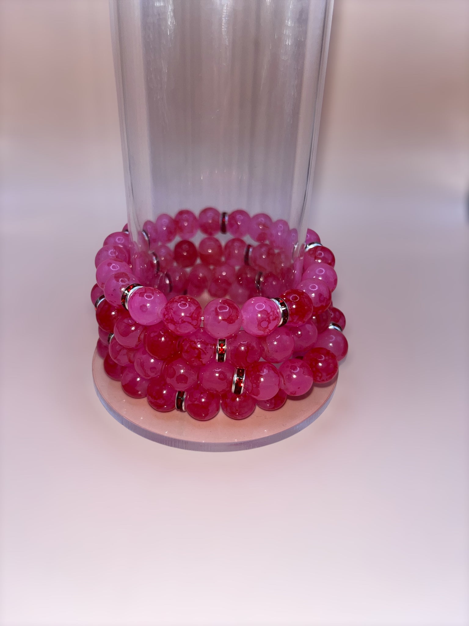 Pink beaded bracelet with red spacers 