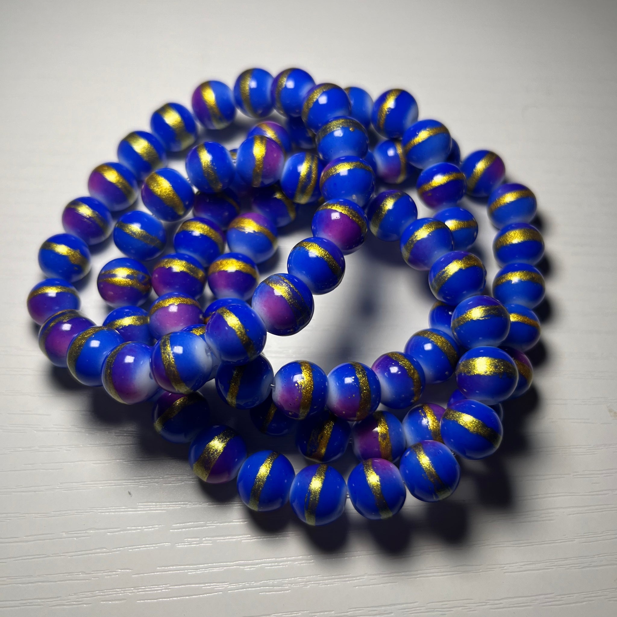 Blue beaded bracelets with gold stripe