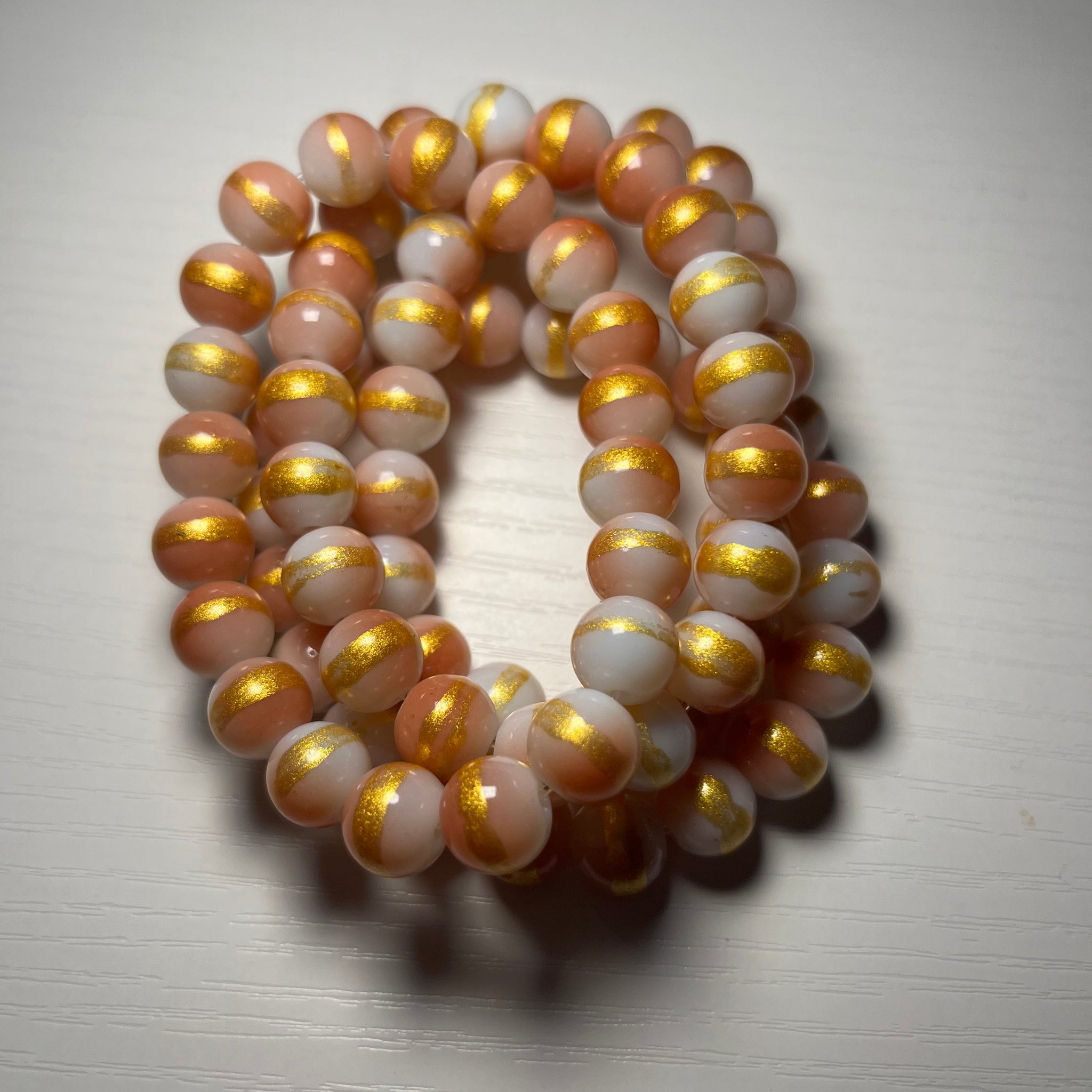 Peach color beaded bracelets with cream and gold