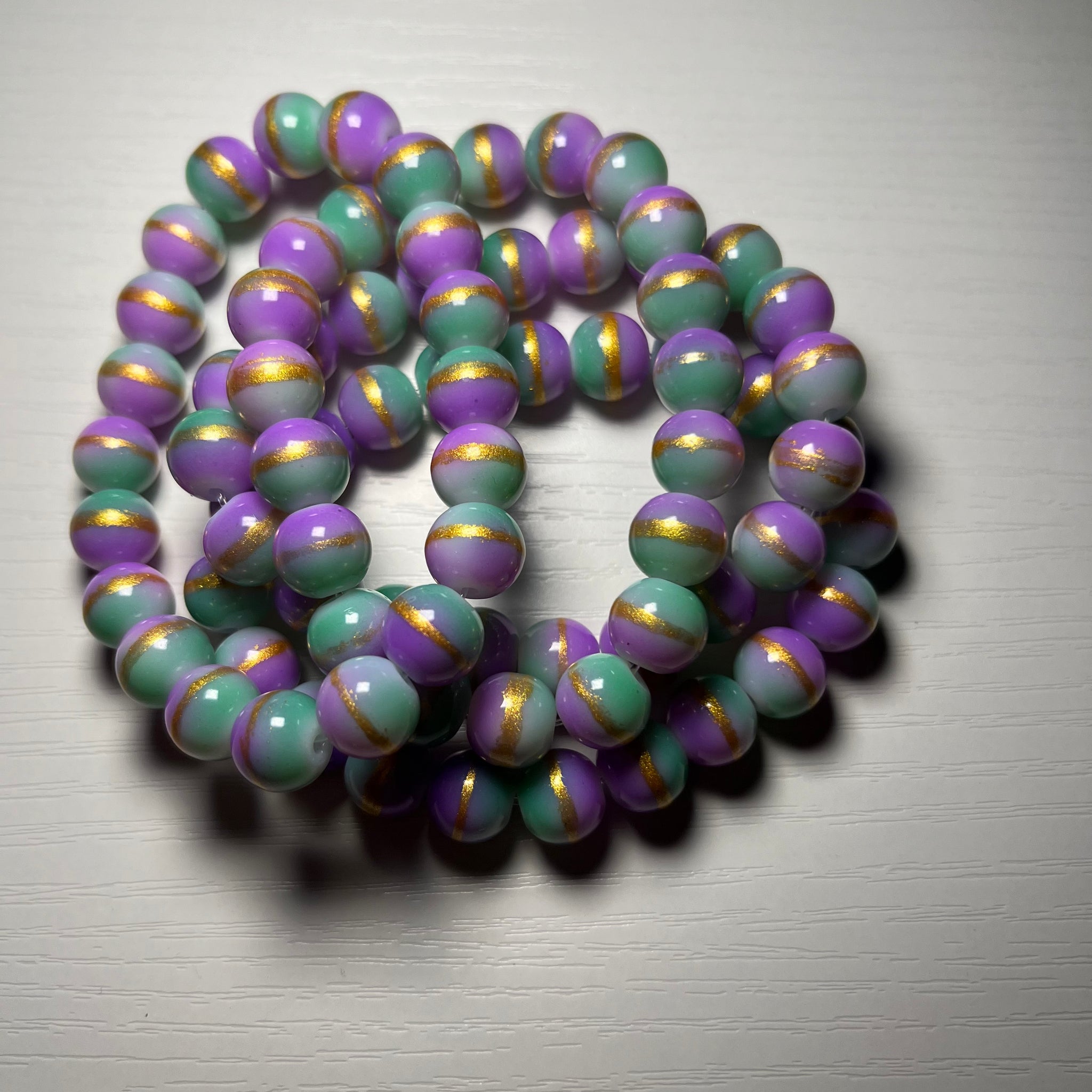 Purple and green beaded bracelet with gold