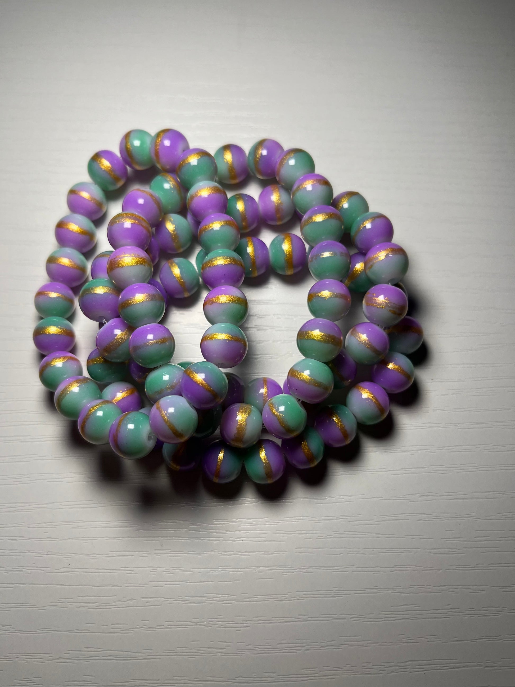 Purple and green beaded bracelet with gold