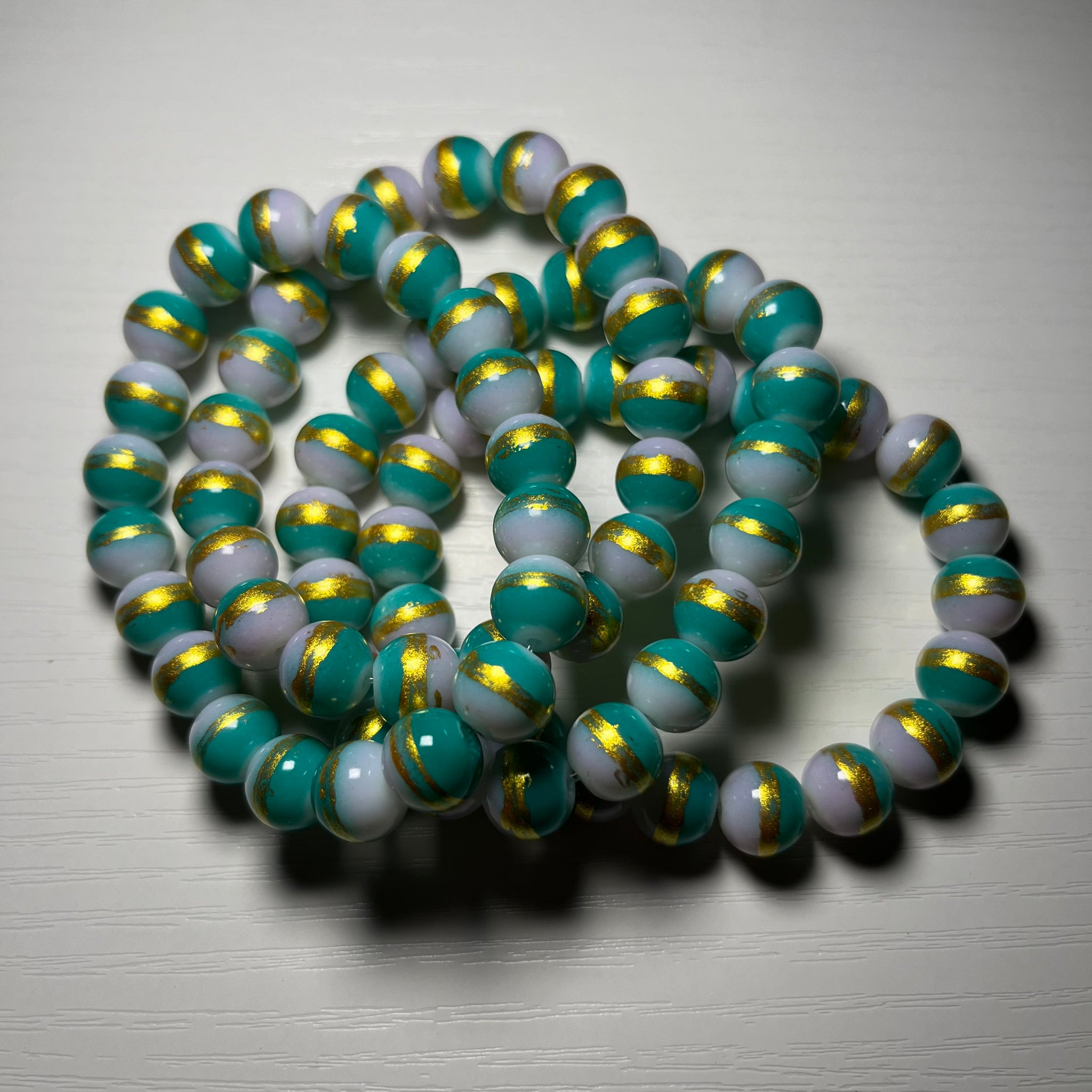 Green beaded bracelets with gold