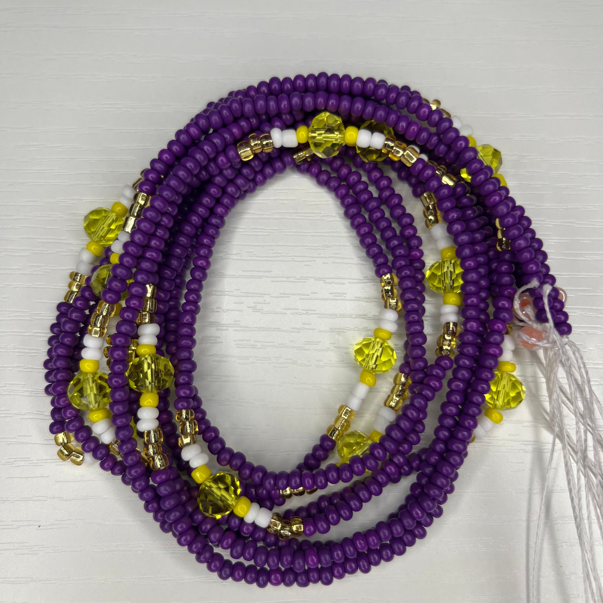 Purple waistbead with yellow white and gold