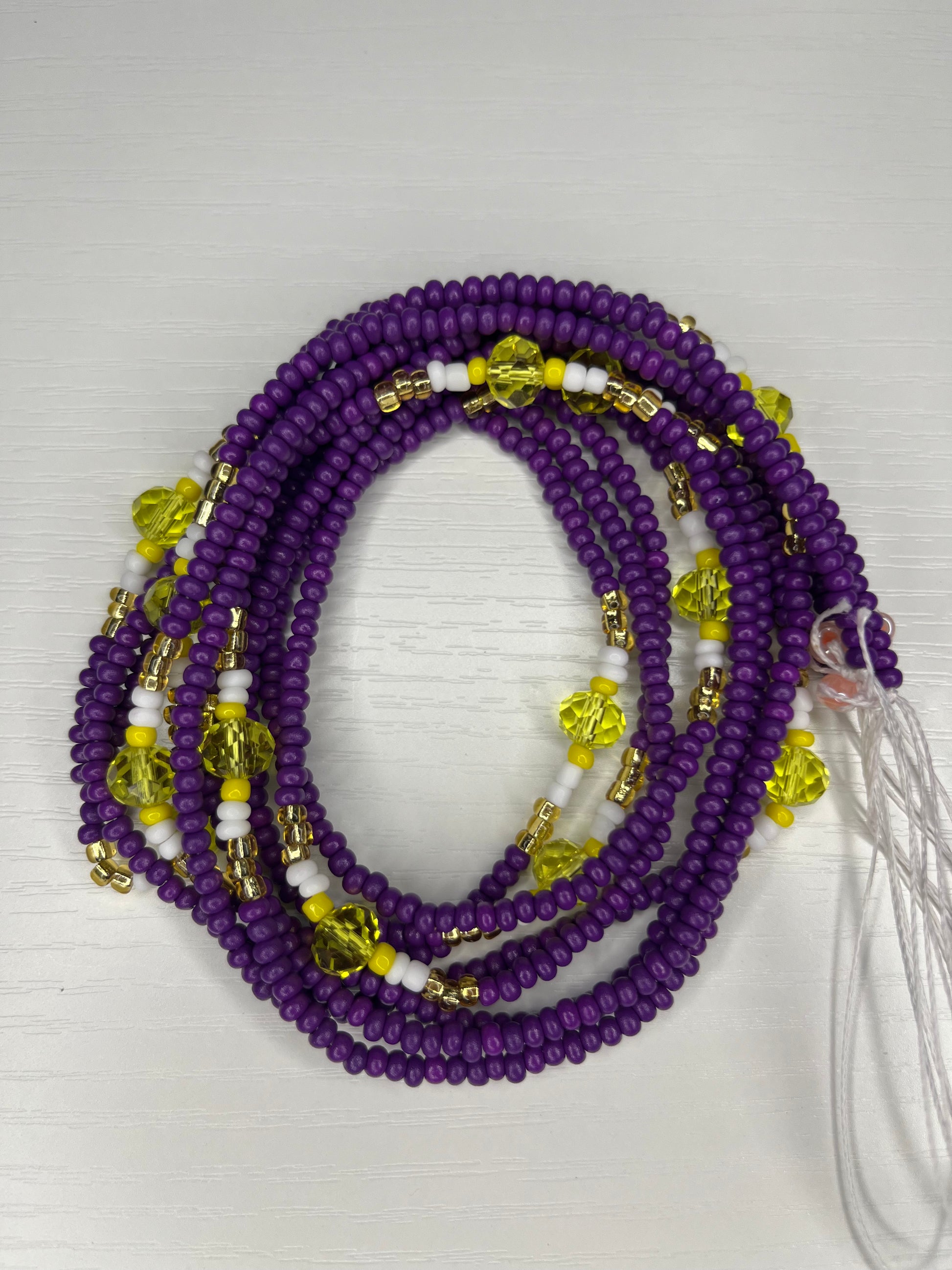 Purple waistbead with yellow white and gold