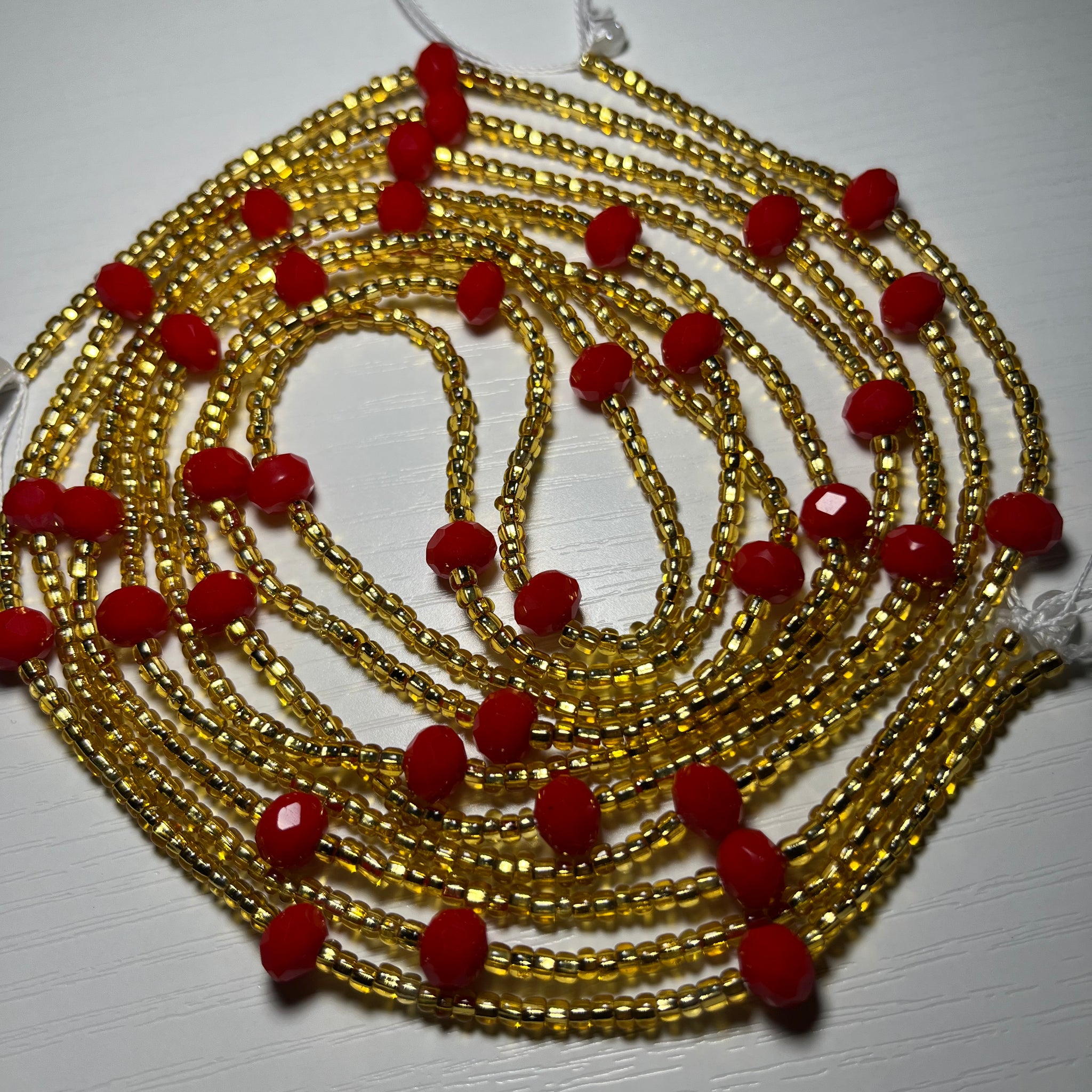 Gold waistbeads with red crystal